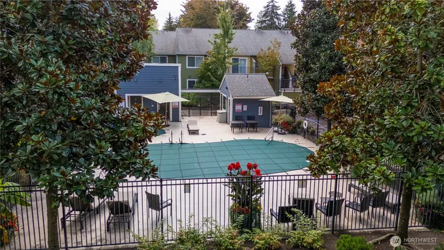 a view of a house with wooden fence and trees