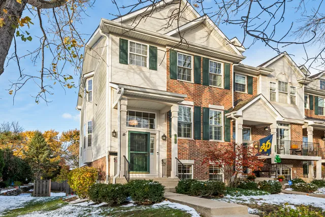 front view of a brick house with a yard