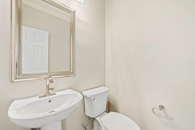 a white toilet sitting next to a white sink