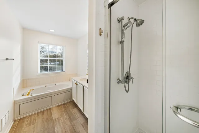 a bathroom with a bathtub shower and a sink
