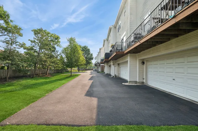 a view of a house with a yard and pathway