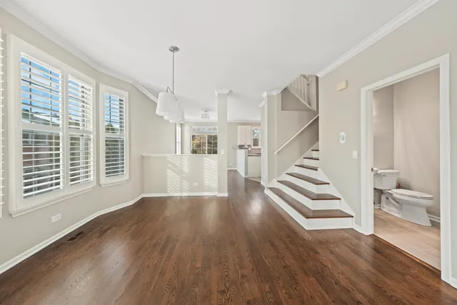 a view of entryway and hall with wooden floor