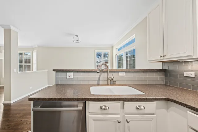 a sink with white cabinets
