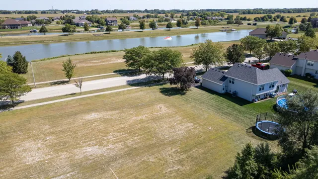 an aerial view of a house with a lake view
