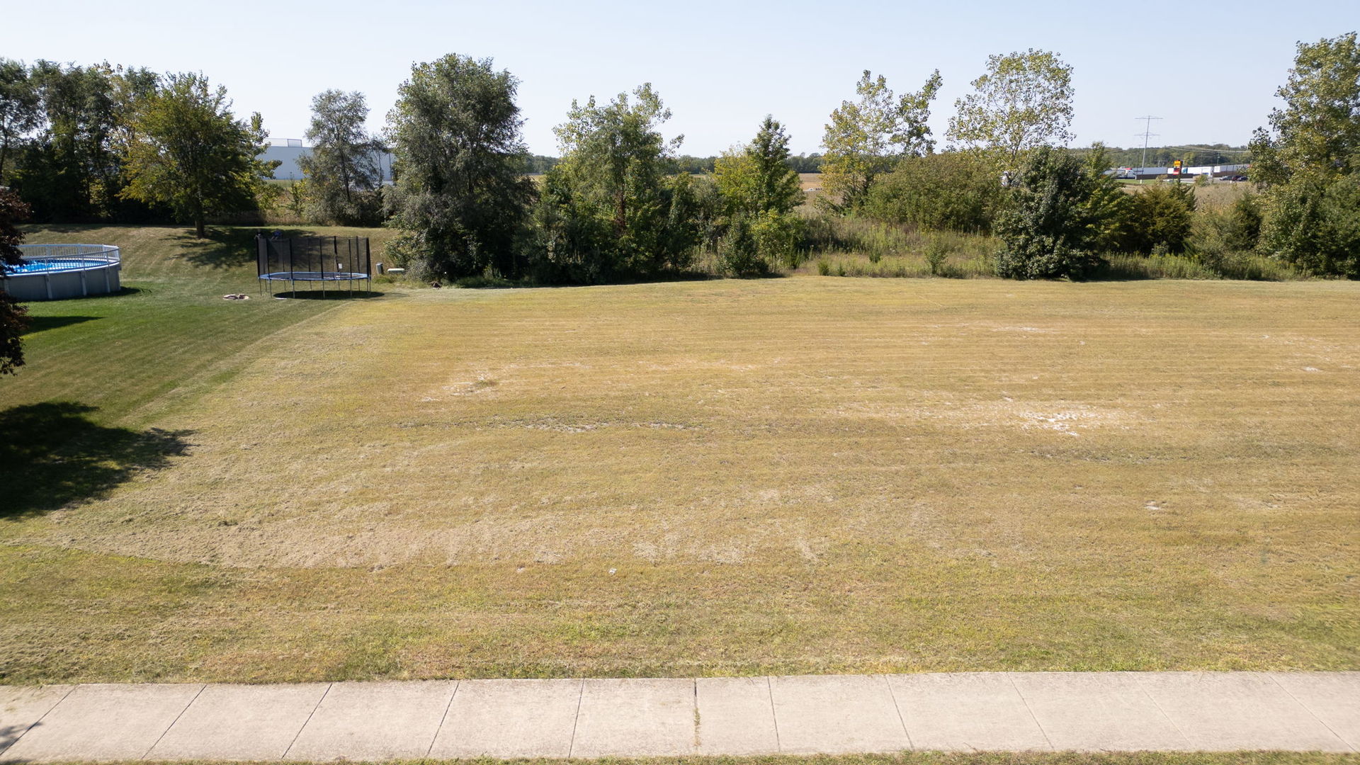 30908 Slalom Lane Wilmington, IL 60481 - Photo 2 of 4 a view of a lake with a yard and trees in the background