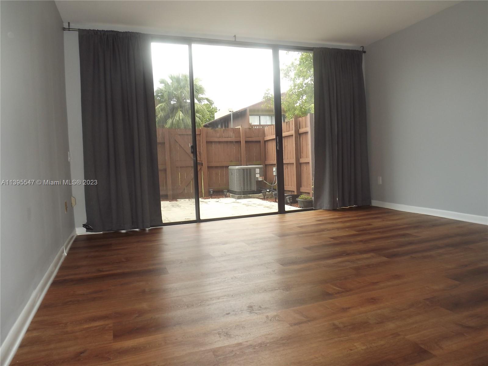 Kendall Miami, FL 33173 - Photo 11 of 34 wooden floor in an empty room with a window
