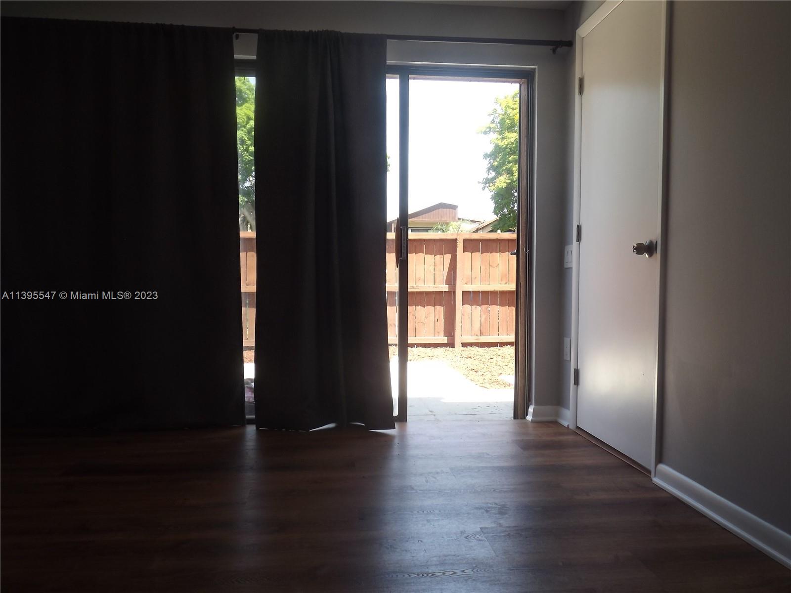 Kendall Miami, FL 33173 - Photo 18 of 34 a view of an empty room with wooden floor and a window