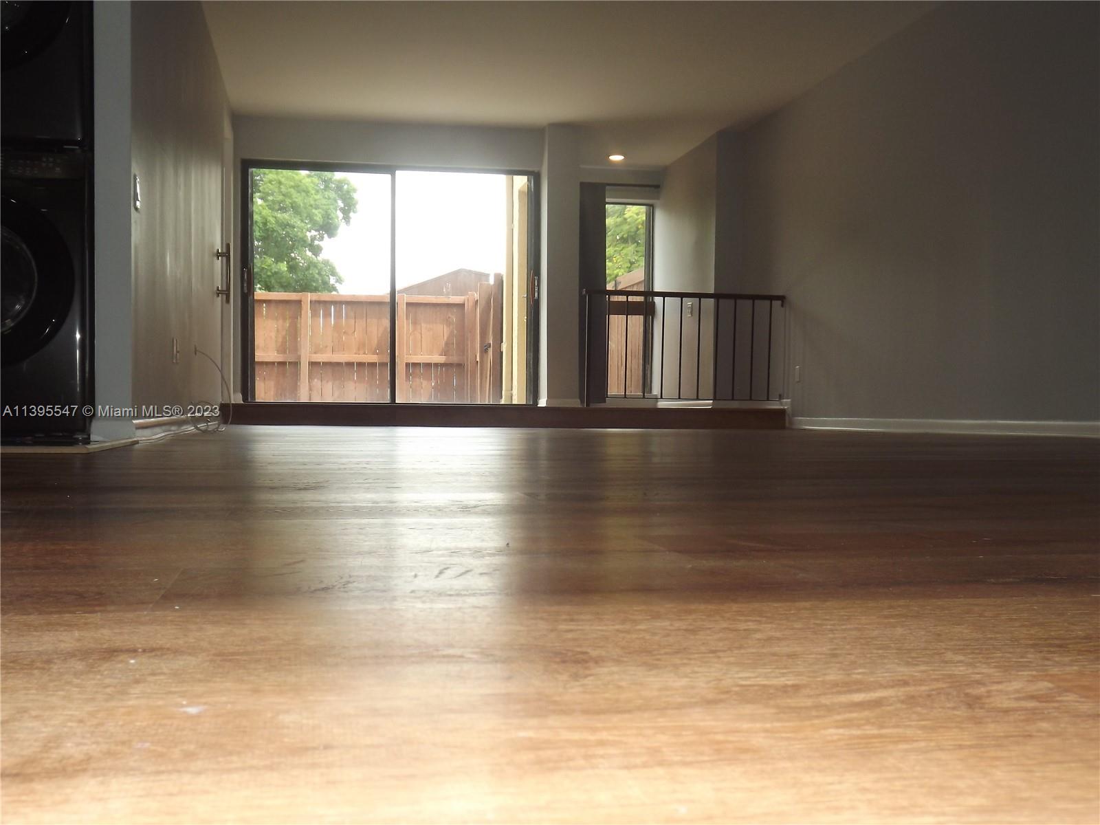 Kendall Miami, FL 33173 - Photo 6 of 34 a view of an empty room with wooden floor and a window