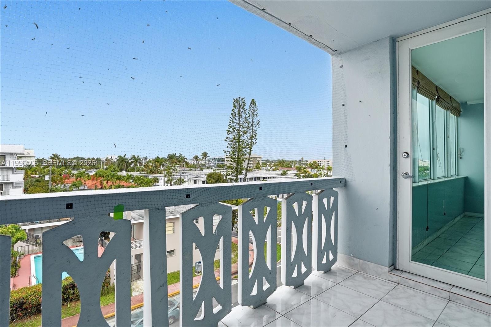 8233 Harding Avenue, Unit 504 Miami Beach, FL 33141 - Photo 14 of 24 a view of a balcony with wooden floor