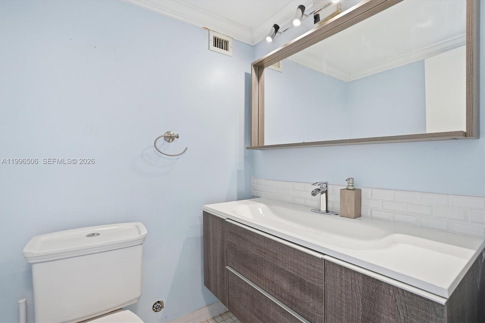 8233 Harding Avenue, Unit 504 Miami Beach, FL 33141 - Photo 15 of 24 a bathroom with a sink a toilet and vanity