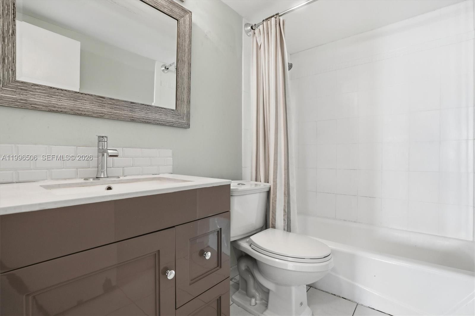 8233 Harding Avenue, Unit 504 Miami Beach, FL 33141 - Photo 16 of 24 a bathroom with a sink a toilet and shower