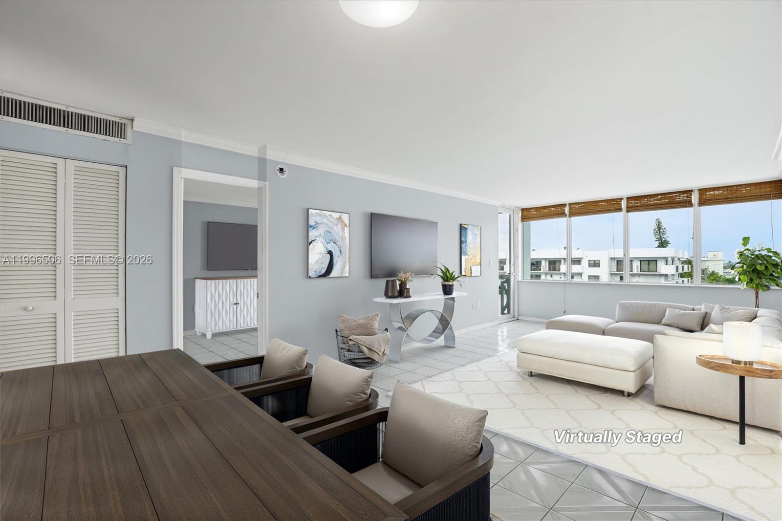 8233 Harding Avenue, Unit 504 Miami Beach, FL 33141 - Photo 3 of 24 a living room with furniture and a large window