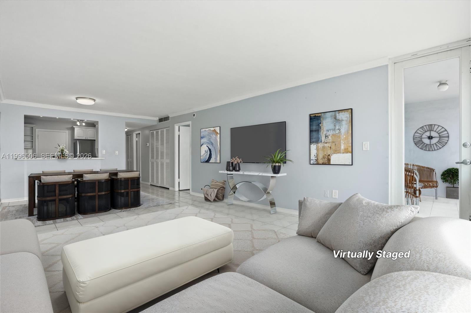 8233 Harding Avenue, Unit 504 Miami Beach, FL 33141 - Photo 7 of 24 a living room with furniture and a flat screen tv