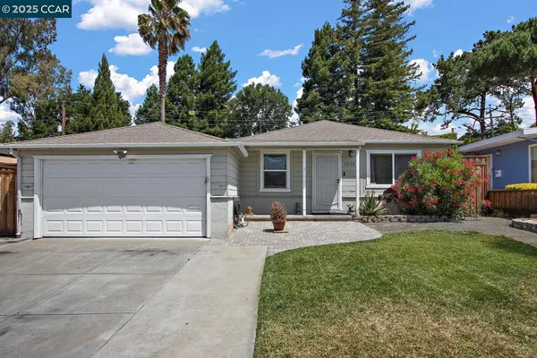 a front view of a house with patio and garden