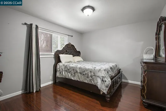a bed sitting in a bedroom next to a window