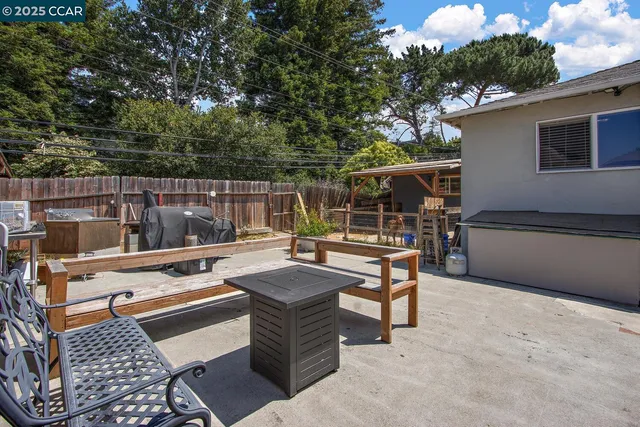 a view of a patio with a table and chairs