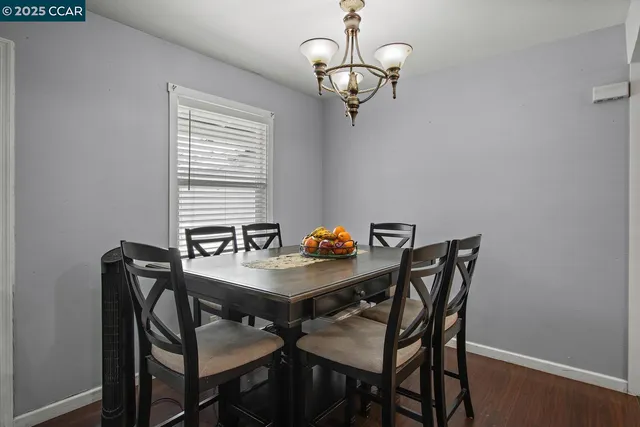 a view of a dining room with furniture and chandelier