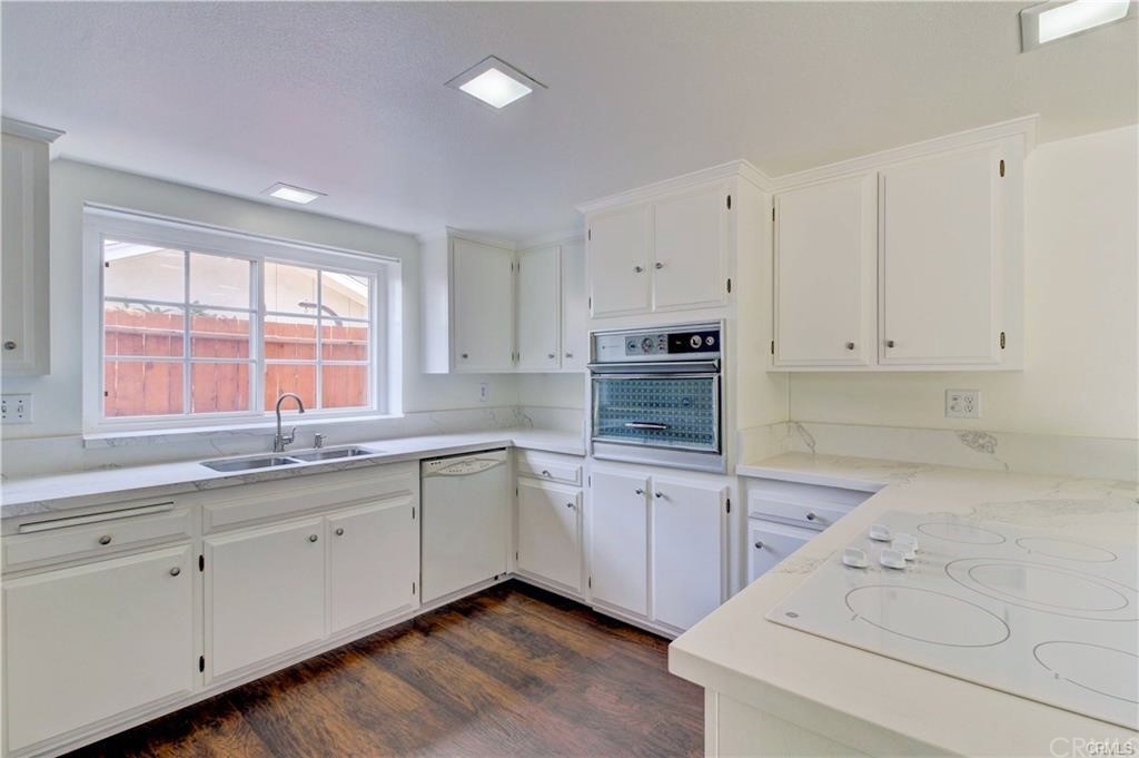 2814 Serang Place Costa Mesa, CA 92626 - Photo 11 of 28 a kitchen with granite countertop white cabinets and white appliances