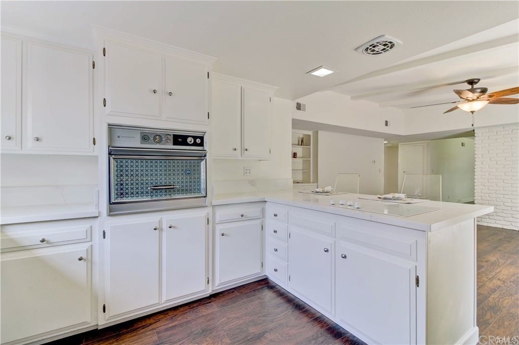 2814 Serang Place Costa Mesa, CA 92626 - Photo 12 of 28 a kitchen with white cabinets and sink