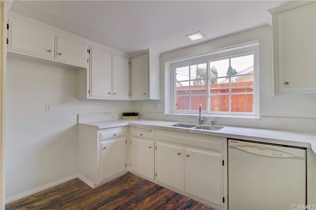 2814 Serang Place Costa Mesa, CA 92626 - Photo 13 of 28 a kitchen with a sink window and cabinets