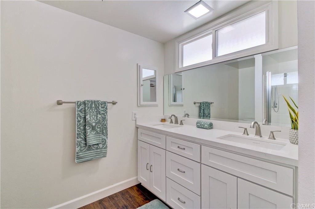 2814 Serang Place Costa Mesa, CA 92626 - Photo 18 of 28 a bathroom with a double vanity sink and a mirror