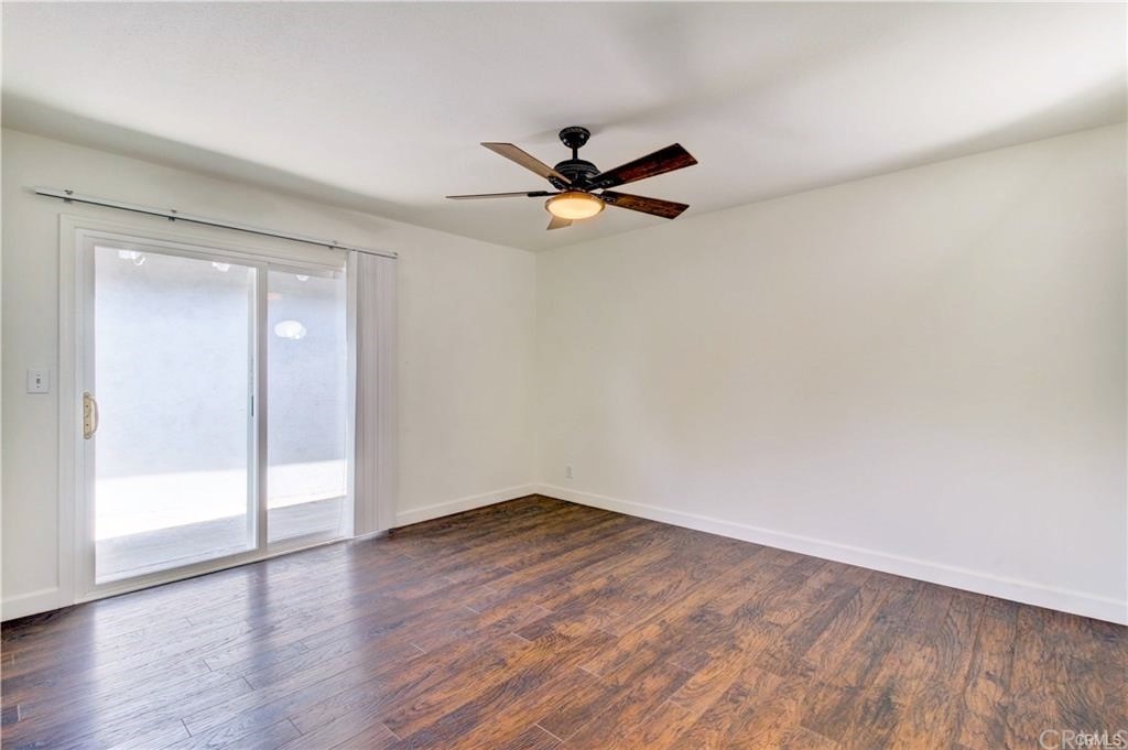 2814 Serang Place Costa Mesa, CA 92626 - Photo 21 of 28 an empty room with wooden floor and windows
