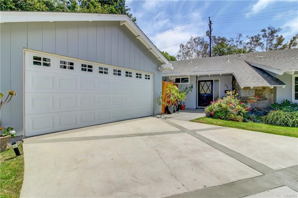 2814 Serang Place Costa Mesa, CA 92626 - Photo 3 of 28 a front view of a house with a yard and garage