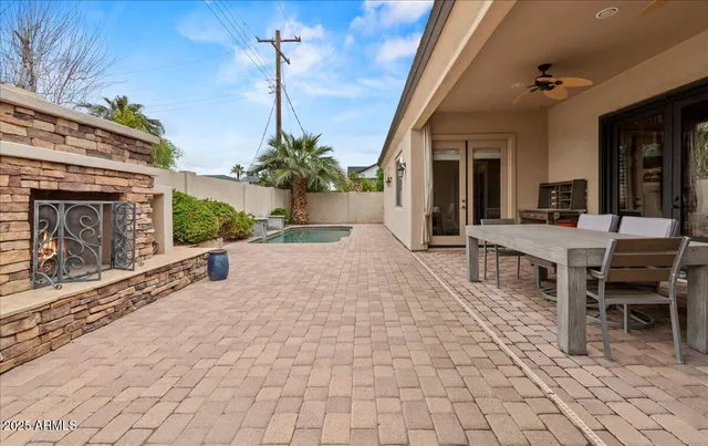 a outdoor space with lots of furniture and a fireplace