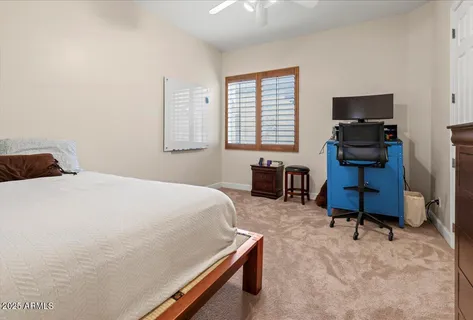 a bathroom with a granite countertop toilet a sink and a mirror