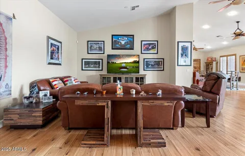 a living room with furniture a fireplace and a floor to ceiling window