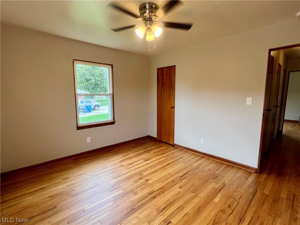 3923 Jaeger Road Lorain, OH 44053 - Photo 10 of 34 Downstairs bedroom 2 with light hardwood flooring and ceiling fan