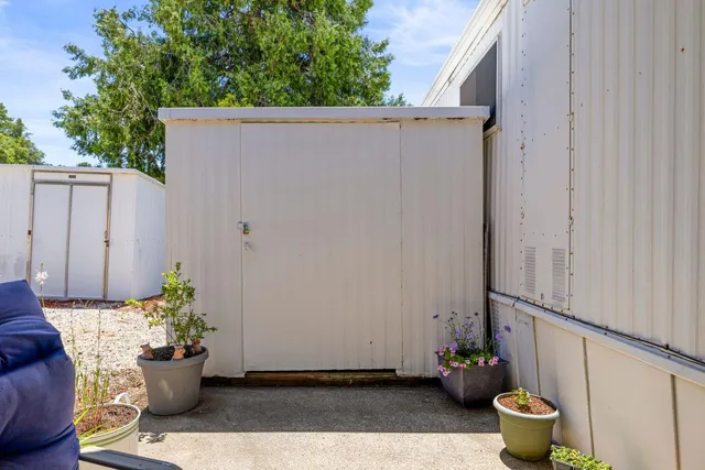 a view of a balcony with chair and potted plant