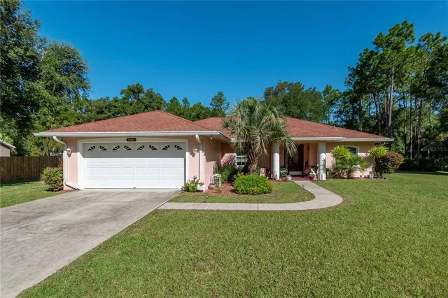 a front view of a house with a yard and garage