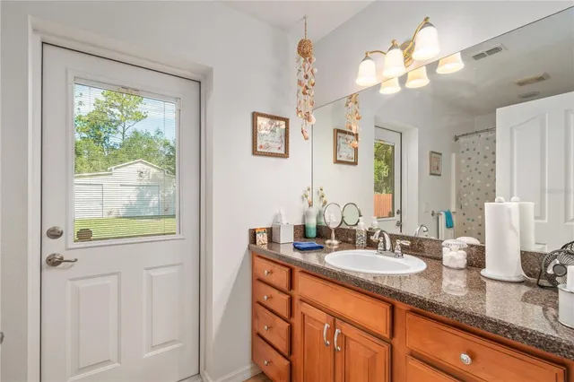 a view of a house with a yard patio and swimming pool