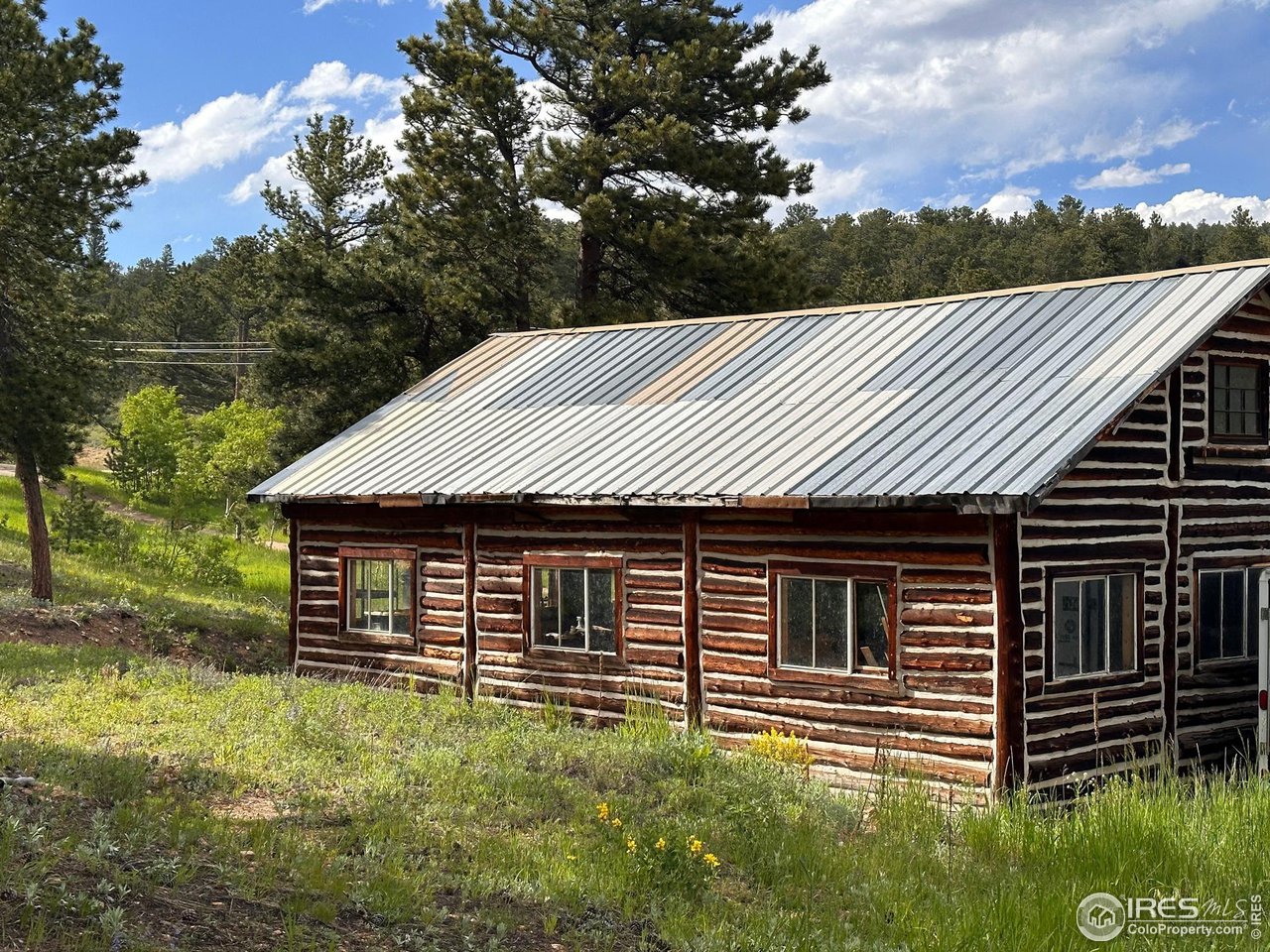 16950 Highway 7 Lyons, CO 80540 - Photo 2 of 9 a backyard of a house with lots of green space