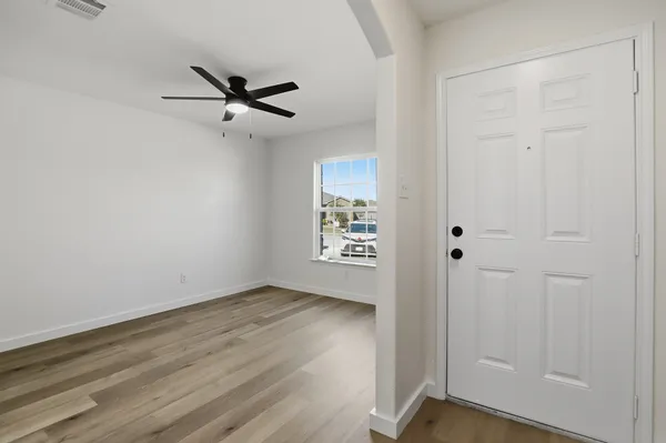 a view of a room with wooden floor