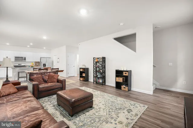 a kitchen with a table chairs refrigerator and cabinets
