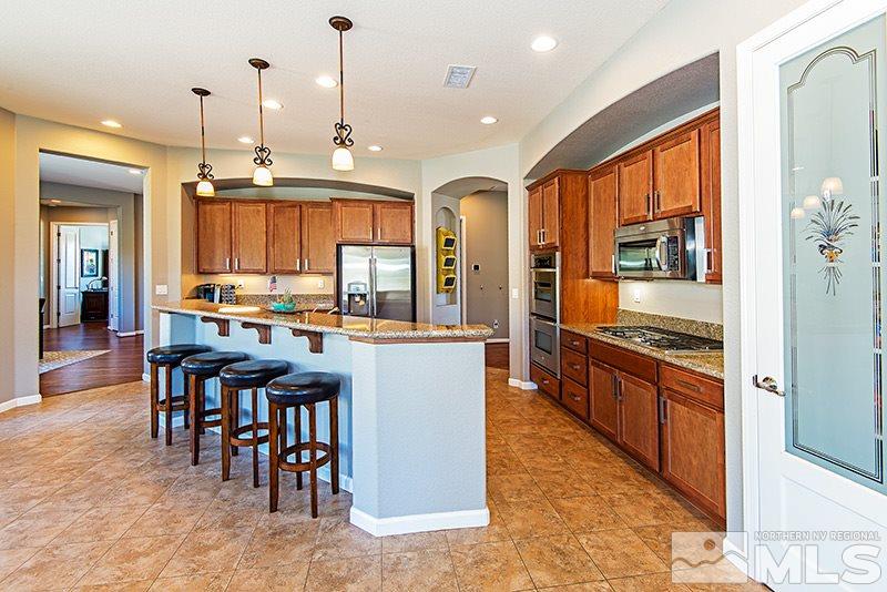 10345 Cavalry Circle Reno, NV 89521 - Photo 3 of 24 a kitchen with lots of counter top space and stainless steel appliances