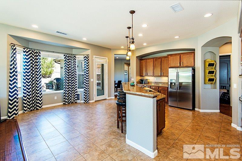 10345 Cavalry Circle Reno, NV 89521 - Photo 4 of 24 a kitchen with stainless steel appliances granite countertop a refrigerator and a sink