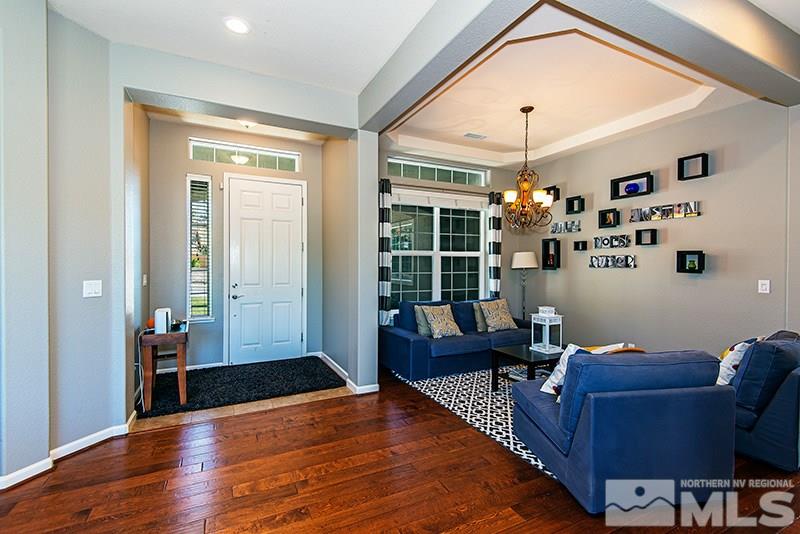 10345 Cavalry Circle Reno, NV 89521 - Photo 7 of 24 a living room with furniture and a chandelier