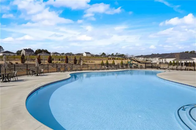 a view of a swimming pool with a table and chairs