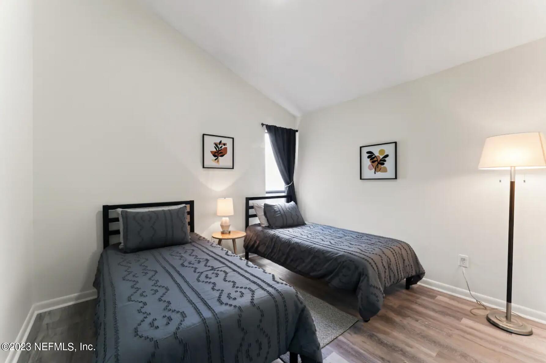 10711 Alden Road, Unit 4 Jacksonville, FL 32246 - Photo 11 of 18 a bedroom with a bed and a lamp