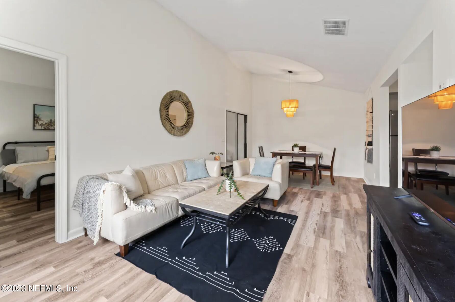 10711 Alden Road, Unit 4 Jacksonville, FL 32246 - Photo 2 of 18 a living room with furniture and a table