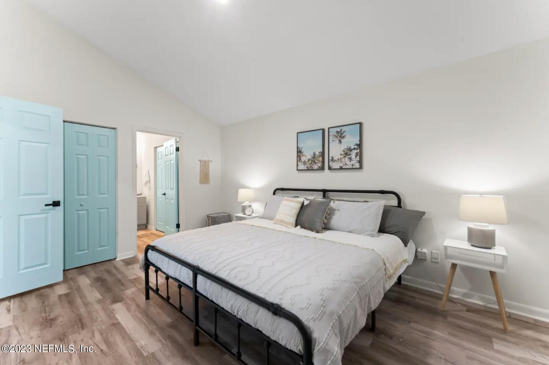 10711 Alden Road, Unit 4 Jacksonville, FL 32246 - Photo 8 of 18 a bedroom with a bed and a lamp on table