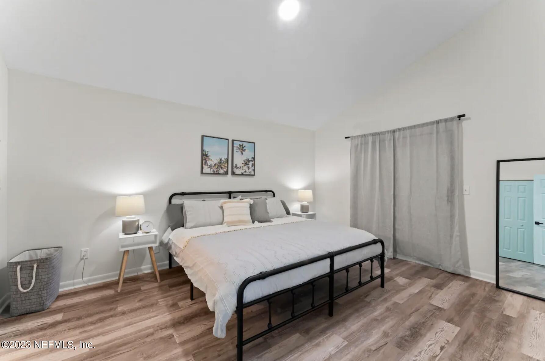 10711 Alden Road, Unit 4 Jacksonville, FL 32246 - Photo 9 of 18 a bedroom with a bed table and a window