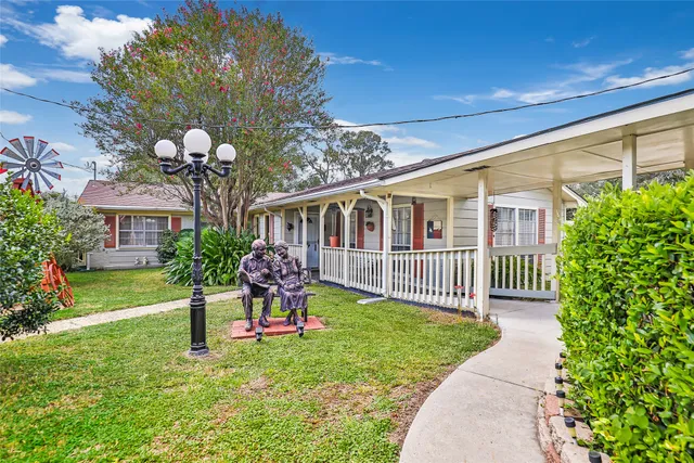 a front view of a house with garden