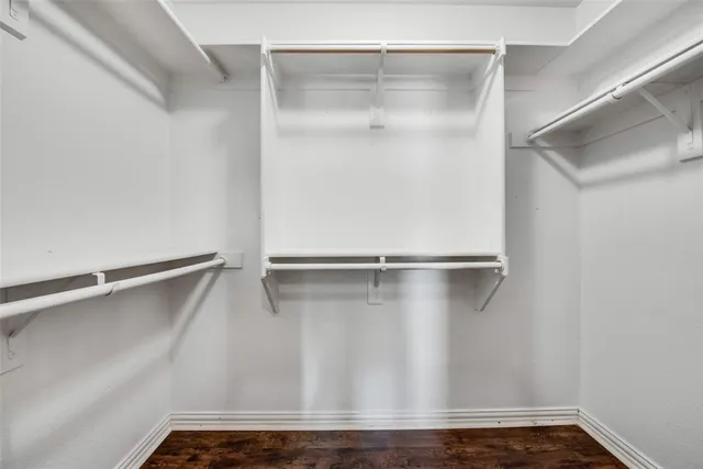 a view of walk in closet with empty racks