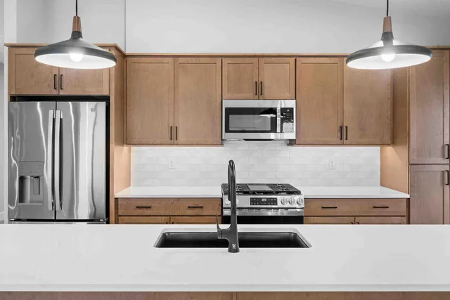 a kitchen with granite countertop a stove and a microwave