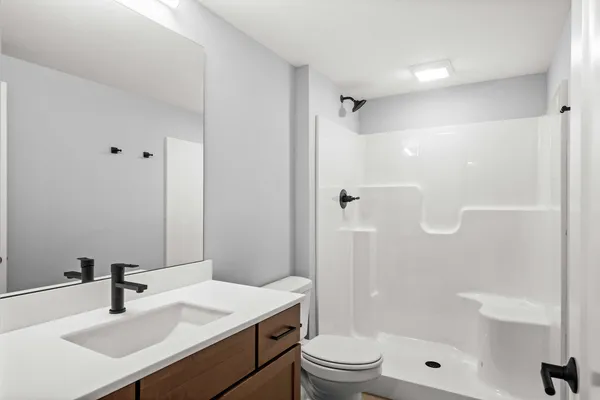 a bathroom with a sink toilet tub and shower