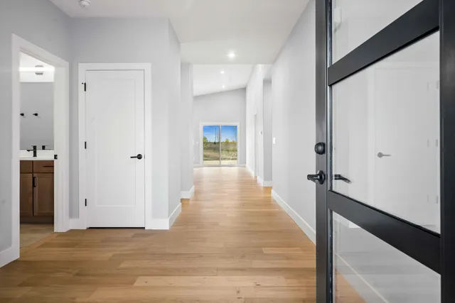 a view of a hallway with wooden floor and staircase